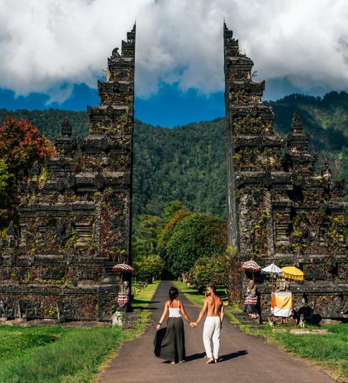 Traveling couple in Bali. Happy couple vacationing in Asian countries. Couple at the Bali gate. A man and a woman traveling on the island of Bali Indonesia. The couple is traveling in Indonesia